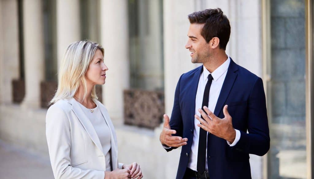 Coworkers communicating effectively after learning how to identify conditioned biases in the workplace from Learn2