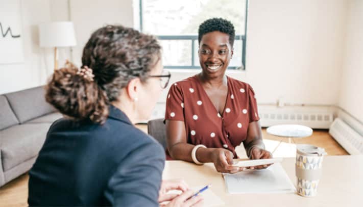 A leadership coach helping an employee